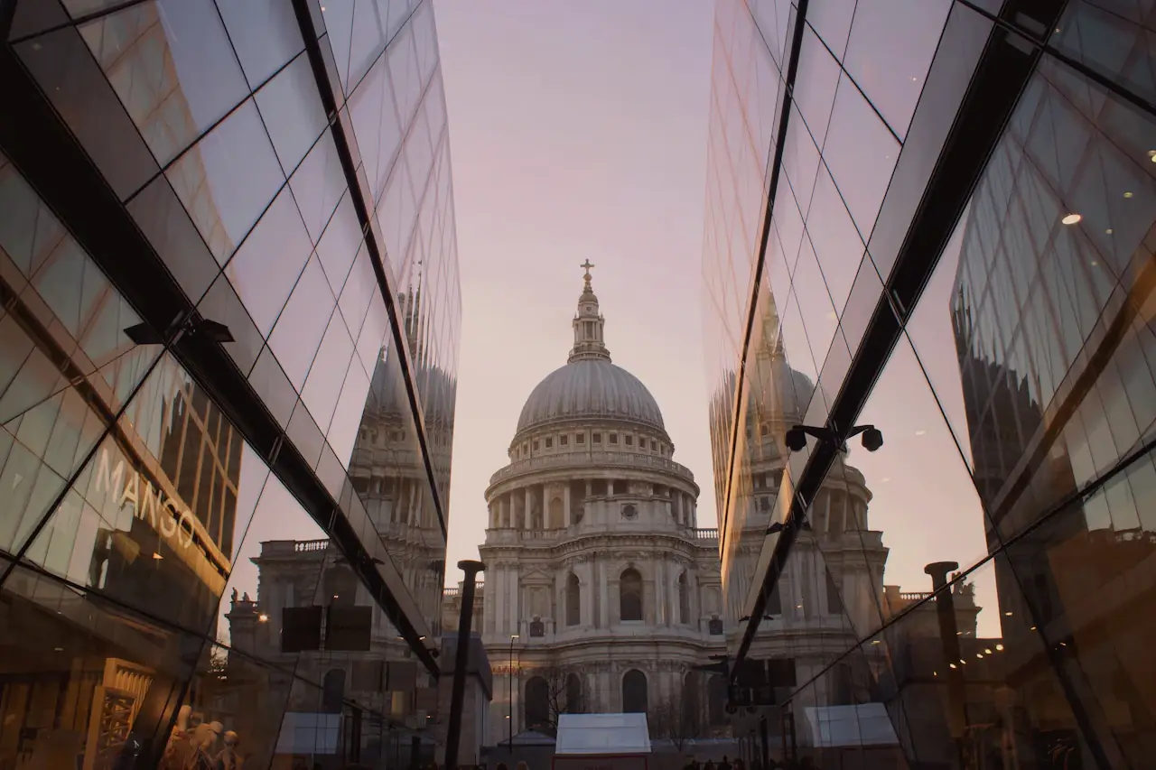 The dome of St Paul's Cathedral framed between glass façades