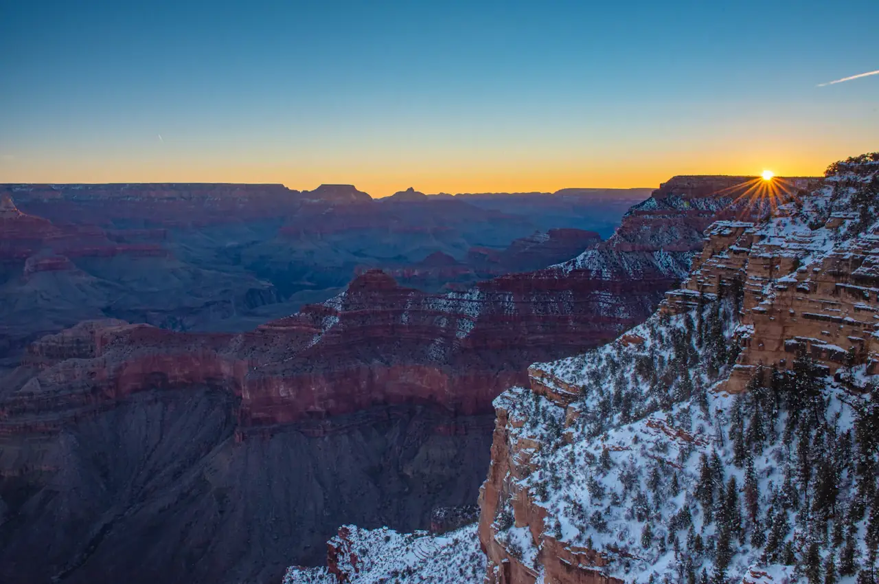 Sunrise over the Grand Canyon in winter, snow on the rim
