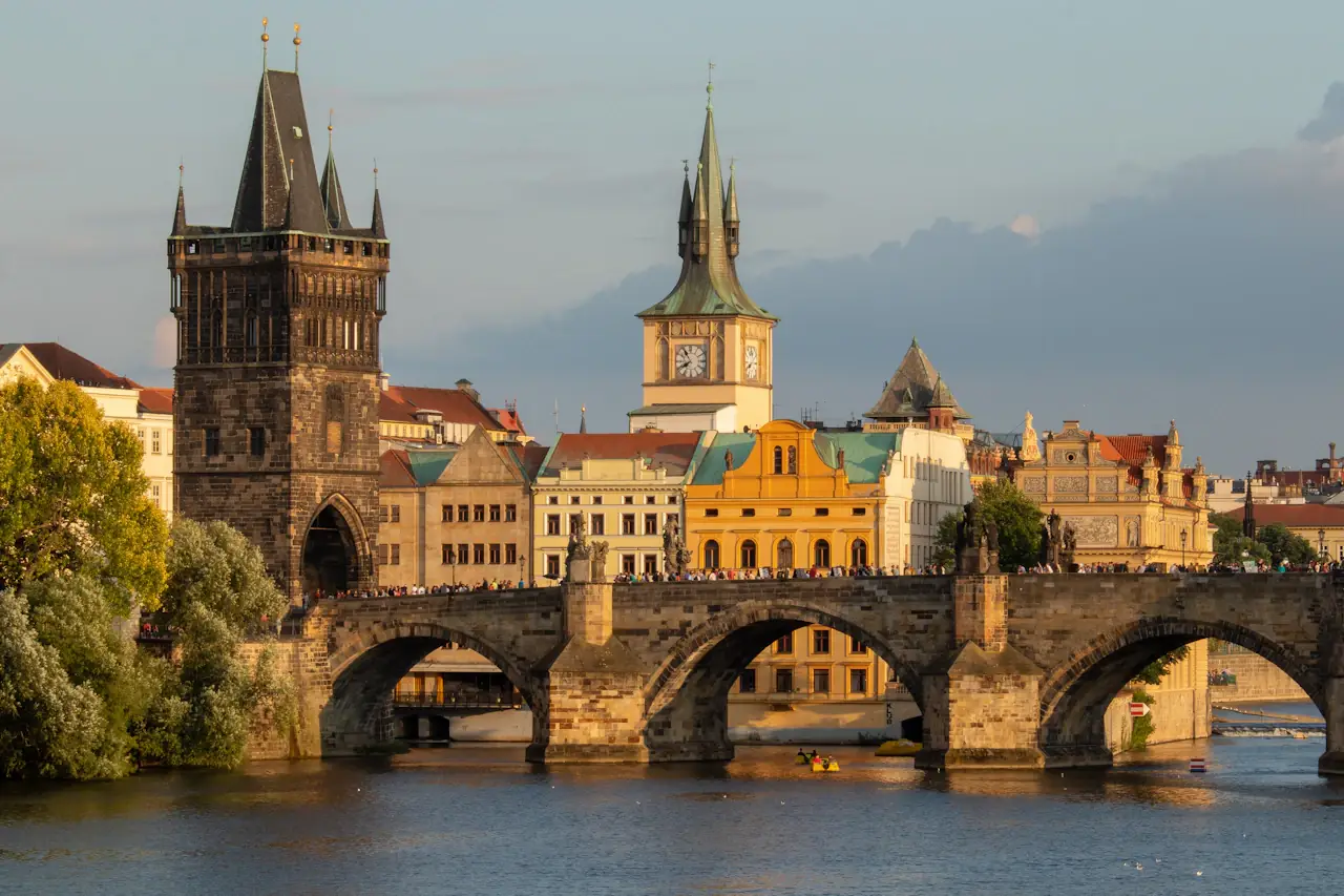 Charles Bridge in Prague with its gate towers and the riverside rooftops