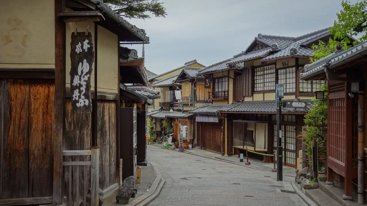 A narrow Kyoto street lined with traditional wooden townhouses