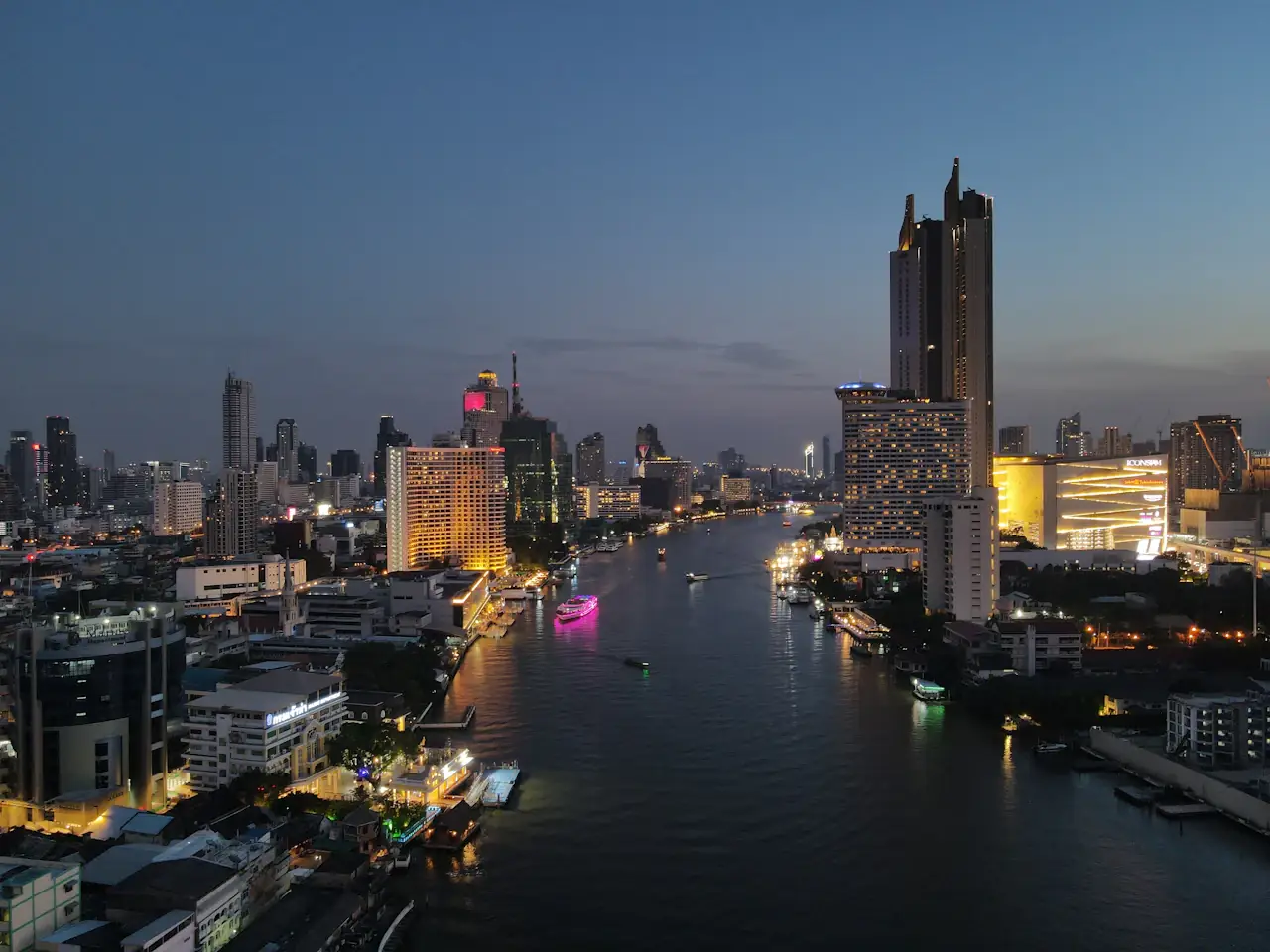 The Chao Phraya River at night with towers on both banks
