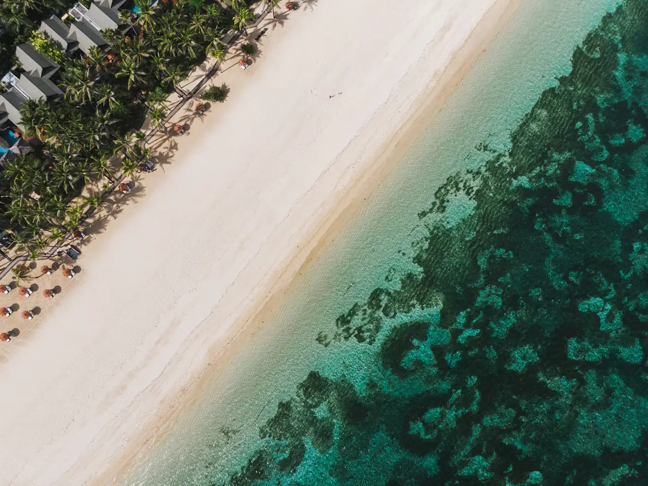 Aerial view of Nusa Dua Beach, white sand beside a turquoise reef flat